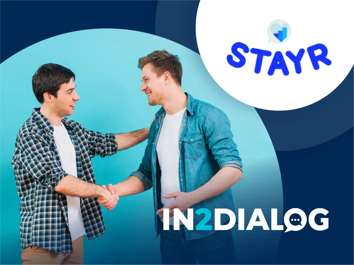 Two Men Handshake In2Dialog and STAYR Partner to Enhance Data-Driven Talent Retention Dark Blue Background